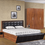 Upgrade your Lagos bedroom with a modern touch! Our “Amen IV” Series Premium Elite 6x6ft bedframe, complete with two matching bedside tables, luxurious black padded headboard, stylish patterned bedding, spacious wooden wardrobe, and elegant framed pictures on chic wallpaper creates the perfect contemporary bedroom setup in Lagos Nigeria. Transform your space today with this stunning and functional bedroom furniture set designed for comfort and style.