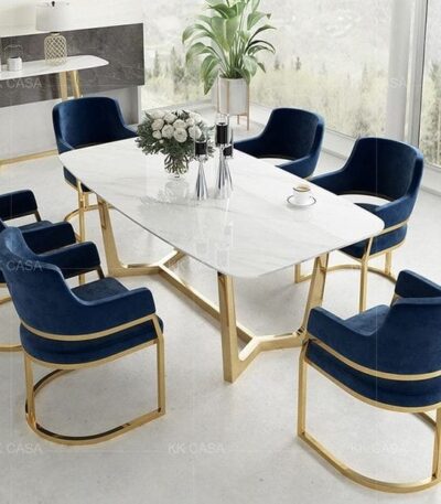 Upgrade your dining space with the “Cassina 001” Elite 6 Seater Dining Set, designed for modern elegance and durability. This luxurious dining table set features a premium quartz marble tabletop and sturdy stainless chrome legs, complemented by six stylish navy blue velvet chairs. Perfect for contemporary dining rooms, the Cassina 001 Elite set offers comfort, sophistication, and lasting quality—ideal for family meals or entertaining guests.