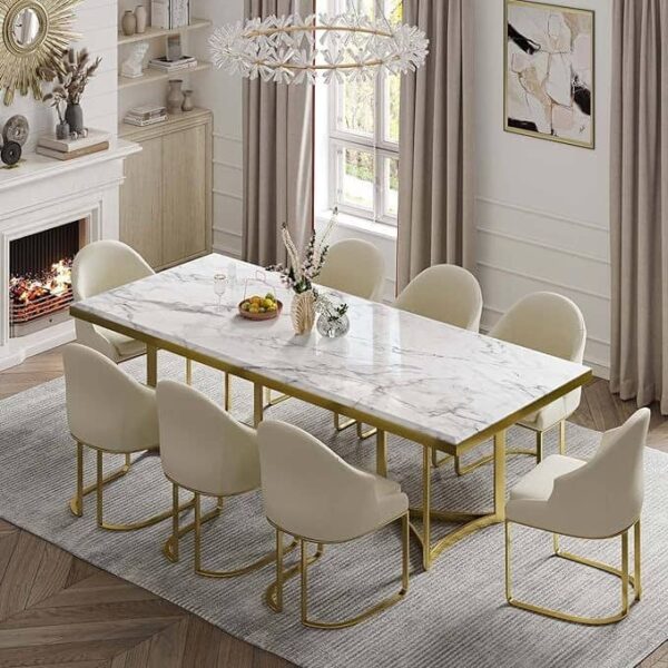 Elevate your dining experience with a modern dining room featuring the luxurious Cassina 003 Series Elite 8 Seater Dining Set. This stunning ensemble includes a quartz marble top table with sleek stainless chrome legs, complemented by comfortable cream chairs and sophisticated gold accents. A statement chandelier illuminates the space, while elegant neutral decor creates a refined and contemporary atmosphere—perfect for upscale entertaining and stylish family dinners.