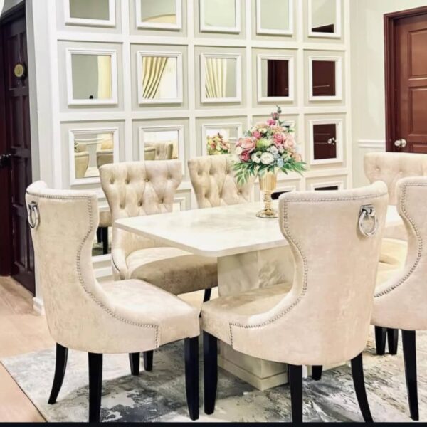 Create an inviting and sophisticated dining experience with the GoodLuck Series Premium 6 Seater Dining Set. Featuring a luxurious cream marble table, this elegant dining room showcases a beautiful floral centerpiece, mirrored wall panels, and stylish modern décor—perfect for both family dinners and entertaining guests. Upgrade your home with this high-quality 6 seater marble dining set for timeless style and comfort.