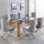 Transform your dining space with the Dove Series IX Premium Stainless Steel 6 Seater Dining Set. Featuring a sleek glass table with elegant gold metal legs and plush gray tufted chairs, this modern dining room set adds a touch of luxury to any home. Gray walls adorned with stylish framed photos create a sophisticated backdrop, while a lush plant centerpiece brings freshness and life to the table. Upgrade your dining room décor today with this contemporary, eye-catching furniture ensemble designed for both style and comfort.